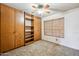 Spacious bedroom featuring a ceiling fan and built-in cabinetry for ample storage and display space at 608 E Arabian Ct, Gilbert, AZ 85296