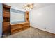 Bedroom with neutral carpet and custom built in shelves and cabinets for ample storage space at 608 E Arabian Ct, Gilbert, AZ 85296