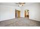 Spacious bedroom with soft carpeting, a ceiling fan, and convenient access to the ensuite bathroom at 608 E Arabian Ct, Gilbert, AZ 85296