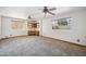 Spacious bedroom featuring neutral carpet and built in desk with backyard pool view through windows at 608 E Arabian Ct, Gilbert, AZ 85296