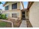 A welcoming front entrance with a secure screen door and a well-maintained landscape at 608 E Arabian Ct, Gilbert, AZ 85296