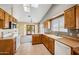 Bright kitchen with wood cabinets, tile floors, a skylight, and a view to the backyard at 608 E Arabian Ct, Gilbert, AZ 85296