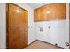 Laundry room featuring tile floor, lots of cabinets, and washer and dryer hookups at 608 E Arabian Ct, Gilbert, AZ 85296