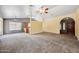 Large carpeted living area offering views of a bar top and the front entrance at 608 E Arabian Ct, Gilbert, AZ 85296