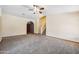 Spacious living room with carpet flooring, ceiling fan and staircase at 608 E Arabian Ct, Gilbert, AZ 85296