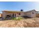 This backyard features a covered patio and grill, perfect for outdoor gatherings at 8051 W Mariposa Dr, Phoenix, AZ 85033