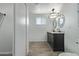 Bathroom features a modern vanity with dual sinks and contemporary light fixtures at 8051 W Mariposa Dr, Phoenix, AZ 85033