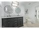 Remodeled bathroom featuring dual sinks, and modern fixtures, enhancing the home's appeal at 8051 W Mariposa Dr, Phoenix, AZ 85033