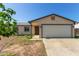 Charming single-story home featuring a neutral color palette, attached garage, and a low-maintenance front yard at 8051 W Mariposa Dr, Phoenix, AZ 85033