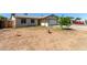 Single-story house featuring a low-maintenance front yard and an attached garage is situated in a quiet neighborhood at 8051 W Mariposa Dr, Phoenix, AZ 85033