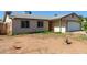 Single-story house featuring a low-maintenance front yard and an attached garage is situated in a quiet neighborhood at 8051 W Mariposa Dr, Phoenix, AZ 85033
