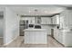 Modern kitchen featuring stainless appliances, an island with pendant lighting, and white cabinetry at 8051 W Mariposa Dr, Phoenix, AZ 85033