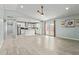 Open concept living area with access to the kitchen, wood-look tile flooring and plenty of natural light at 8051 W Mariposa Dr, Phoenix, AZ 85033