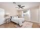 Bedroom boasts wood floors, a ceiling fan, and a large window for natural light at 8103 E Dartmouth St, Mesa, AZ 85207