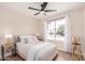 Bright bedroom with ceiling fan featuring neutral walls and a large window letting in natural light at 8103 E Dartmouth St, Mesa, AZ 85207