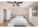 Bedroom boasts wood floors, a ceiling fan, and a large window for natural light at 8103 E Dartmouth St, Mesa, AZ 85207