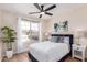 Comfortable bedroom featuring neutral colored walls, an overhead fan and a large window letting in natural light at 8103 E Dartmouth St, Mesa, AZ 85207
