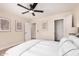 Bright bedroom with ceiling fan featuring neutral walls and a large window letting in natural light at 8103 E Dartmouth St, Mesa, AZ 85207