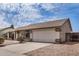 Well-maintained single-story home with a two-car garage and low-maintenance landscaping in front at 8103 E Dartmouth St, Mesa, AZ 85207
