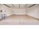 Clean, spacious garage with sealed concrete floor, white walls, and ample room for parking and storage at 8103 E Dartmouth St, Mesa, AZ 85207