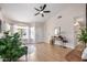Cozy living room area with neutral colors, hardwood floors, ceiling fan, and a glimpse into the entryway at 8103 E Dartmouth St, Mesa, AZ 85207