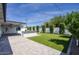 Spacious backyard featuring lush artificial grass, a built-in BBQ, a covered patio, and pavers at 8318 E Sells Dr, Scottsdale, AZ 85251