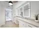 Modern bathroom with a marble shower, double vanity, and stylish, well-lit mirrors at 8318 E Sells Dr, Scottsdale, AZ 85251