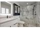 Beautifully remodeled bathroom featuring marble walls, a frameless glass shower, and a modern vanity at 8318 E Sells Dr, Scottsdale, AZ 85251
