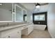 Modern bathroom featuring double vanity, a freestanding tub with a black tile accent wall, and light wood flooring at 8318 E Sells Dr, Scottsdale, AZ 85251
