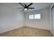 The bedroom has wood floors, a fan and plantation shutters for filtered light at 8318 E Sells Dr, Scottsdale, AZ 85251