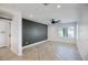Bedroom with a modern ceiling fan, beautiful window, and a stylish accent wall at 8318 E Sells Dr, Scottsdale, AZ 85251