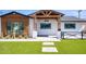 Modern home featuring a black trimmed windows and a well manicured yard at 8318 E Sells Dr, Scottsdale, AZ 85251