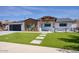 Charming single-story home with modern black garage and manicured front yard at 8318 E Sells Dr, Scottsdale, AZ 85251