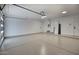 Spacious three car garage with epoxy floors and white walls offers ample parking and storage at 8318 E Sells Dr, Scottsdale, AZ 85251
