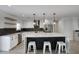 Stylish kitchen with a large island, stainless steel appliances, and white cabinetry at 8318 E Sells Dr, Scottsdale, AZ 85251