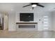 Bright living room featuring a modern fireplace and wood grain tile at 8318 E Sells Dr, Scottsdale, AZ 85251