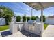 Outdoor kitchen boasts stainless steel BBQ, sink, drawers, gray granite counter, and patterned tile base at 8318 E Sells Dr, Scottsdale, AZ 85251
