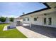 Large patio with pavers, a built-in BBQ, a covered space with a fan, and double doors at 8318 E Sells Dr, Scottsdale, AZ 85251