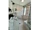 The marbled walk-in shower has a glass surround, bench and upgraded shower heads at 8318 E Sells Dr, Scottsdale, AZ 85251