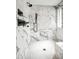Modern shower with gorgeous tile, rainfall showerhead, and other stylish fixtures at 8318 E Sells Dr, Scottsdale, AZ 85251