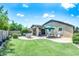 Inviting backyard with lush lawn, covered patio, seating, and manicured landscaping at 907 E Kelsi Ave, San Tan Valley, AZ 85140