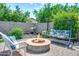 Charming backyard with a stylish fire pit, swing and comfortable seating, ideal for outdoor gatherings and relaxation at 907 E Kelsi Ave, San Tan Valley, AZ 85140