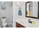 Well-lit bathroom with a white countertop, vanity mirror, and decorative artwork enhancing the space at 907 E Kelsi Ave, San Tan Valley, AZ 85140