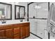 Bathroom with a dual sink wood vanity and a glass-enclosed shower at 907 E Kelsi Ave, San Tan Valley, AZ 85140