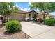Inviting single-story home with well-manicured landscaping, a two-car garage, and a concrete driveway at 907 E Kelsi Ave, San Tan Valley, AZ 85140