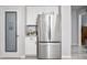 Kitchen features a stainless steel refrigerator and a door leading to a pantry at 907 E Kelsi Ave, San Tan Valley, AZ 85140