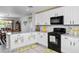 Modern kitchen with white cabinets, granite countertops, and stainless steel appliances at 907 E Kelsi Ave, San Tan Valley, AZ 85140