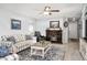 Comfortable living room with a fireplace, ceiling fan, and stylish furnishings at 907 E Kelsi Ave, San Tan Valley, AZ 85140