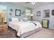 Spacious bedroom with soft colors, a ceiling fan, and multiple windows at 907 E Kelsi Ave, San Tan Valley, AZ 85140