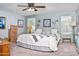 Serene bedroom features soft blue walls, neutral bedding, and ample natural light at 907 E Kelsi Ave, San Tan Valley, AZ 85140